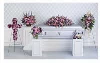 Pink floral funeral casket spray with matching standing arrangements