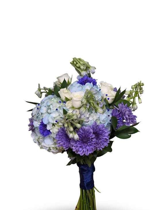 Blue Belle Prom Posy - Soft pale blue hydrangeas set a cool, romantic tone in this event bouquet-perfect as a prom posy bouquet. The Blue Belle Posy pairs white roses and lavender-purple chrysanthemums with daisy-like blooms to create a refined, slightly formal look that still feels tender and personal. The rounded, hand-tied shape reads elegant against a dress or table setting and makes the recipient feel truly noticed.   The bouquet is finished with a wrapped handle and a blue ribbon for secure, comfortable carrying and coordinated style. Posy will come in a small vase with minimal water to keep arrangement fresh.