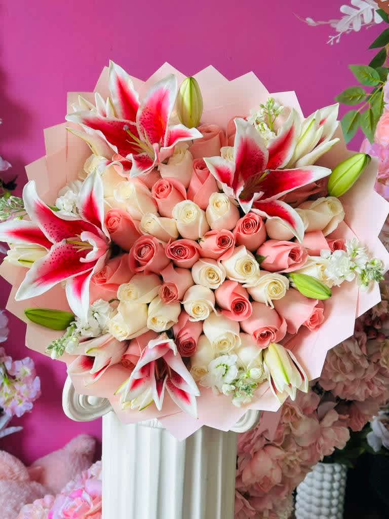 Bouquet of pink and white roses with red-and-white lilies