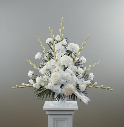 Eternal Peace Pedestal Arrangement - Filled with football mums, gladiolus, carnations, and chrysanthemums, our Eternal Peace Pedestal Arrangement conveys a tender expression of love.  Approximately 36" tall x 40" wide  Please Note: While we always try to follow the color palette, we may substitute blooms to deliver the freshest bouquet in time for a memorial service, funeral, or visitation. Substitutions are likely for both flowers and vase and will always be of equal or greater value to the original design. 