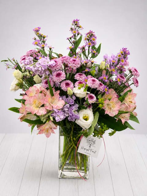 Mixed pink and purple bouquet in a clear glass vase