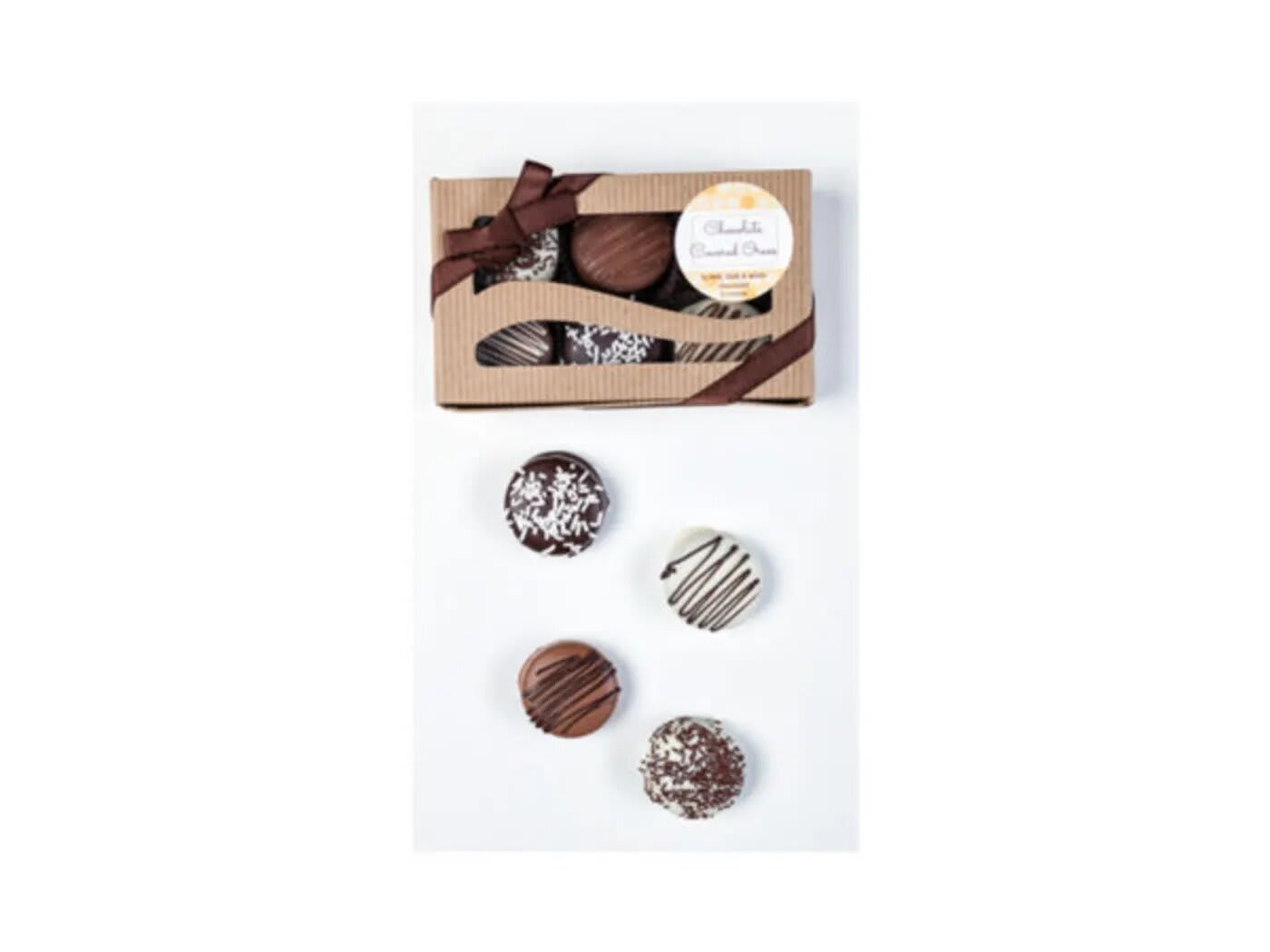 Gift box of assorted chocolate-covered cookies with four decorated cookies displayed below.
