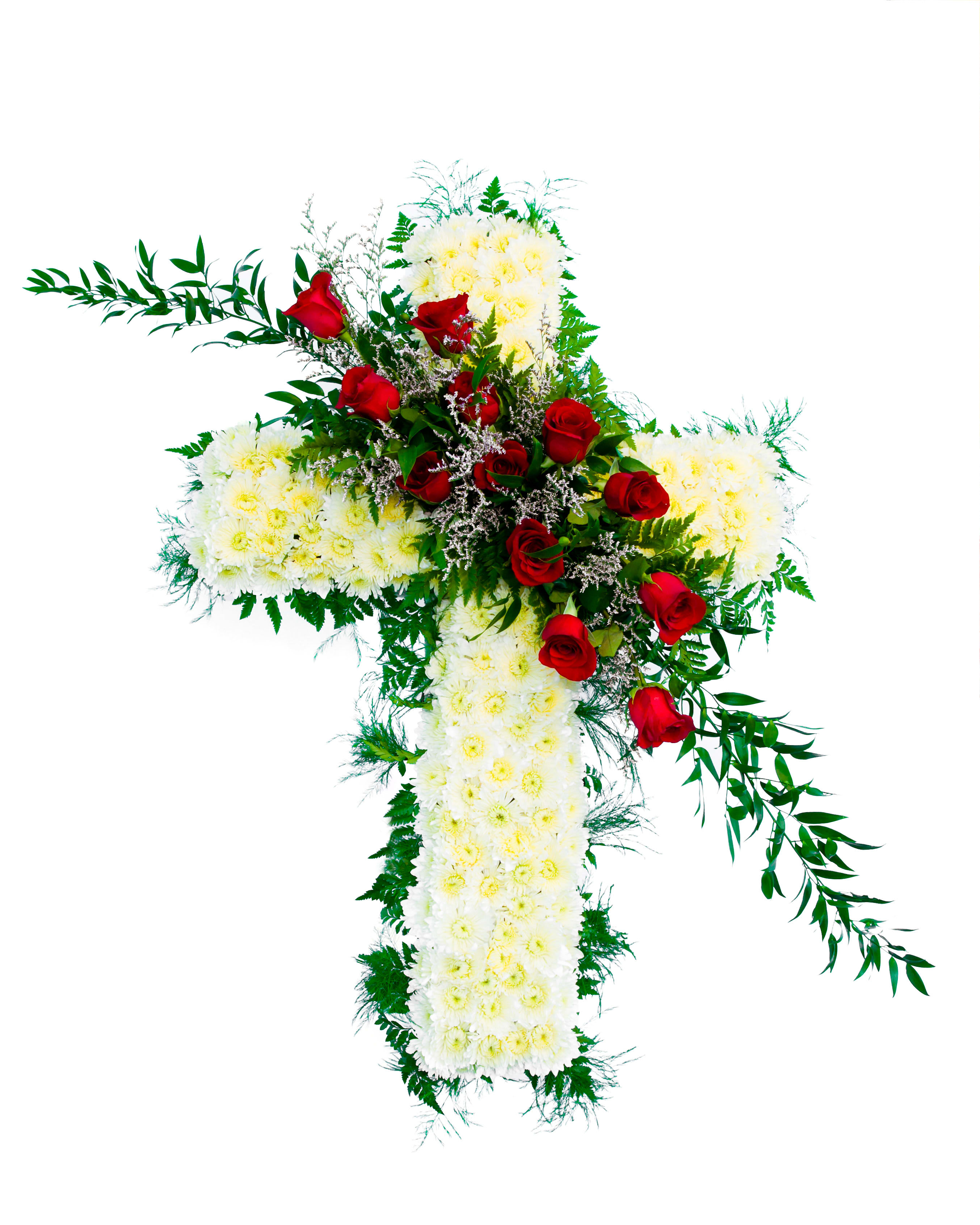 Heartfelt Cross Standing Spray (BB) - Honor the memory of a beloved individual with our elegant standing cross spray, designed to infuse your loved one's service with a graceful, serene atmosphere. This striking arrangement features a base of delicate white poms, with accents of deep red roses and lush greenery, carefully arranged in the shape of a standing cross.