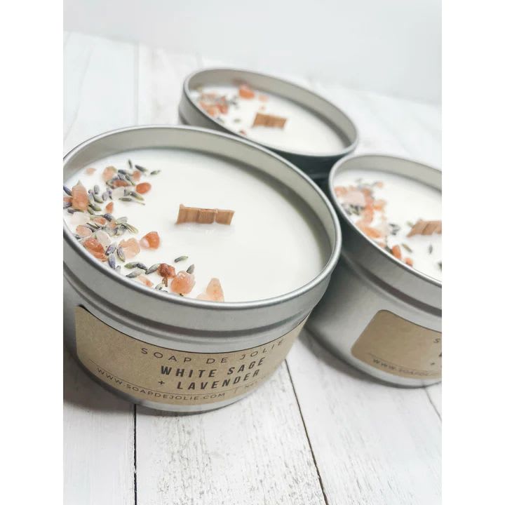 Three tin candles with white wax and floral topping