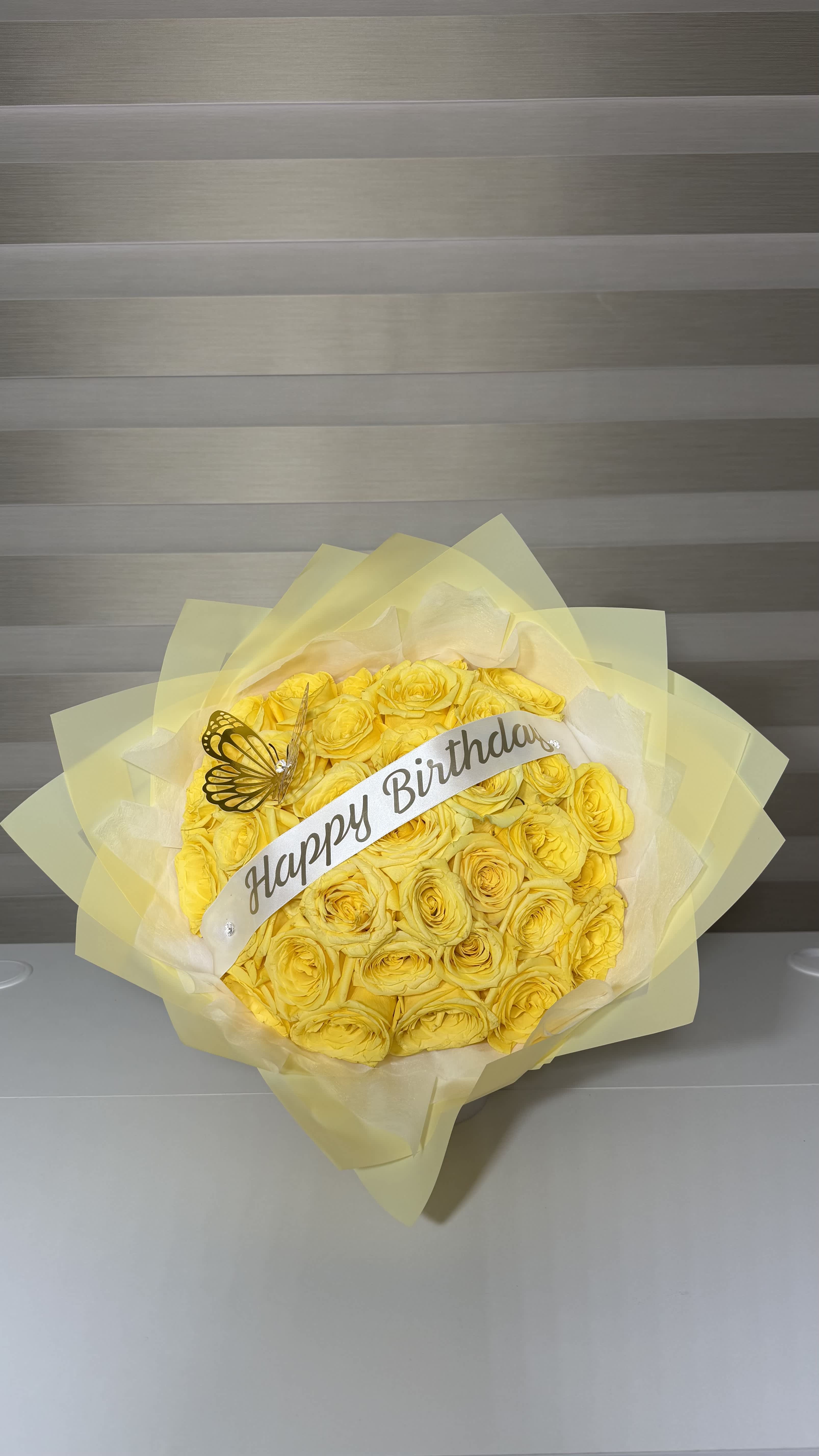 Yellow rose bouquet with a Happy Birthday ribbon and butterfly decoration
