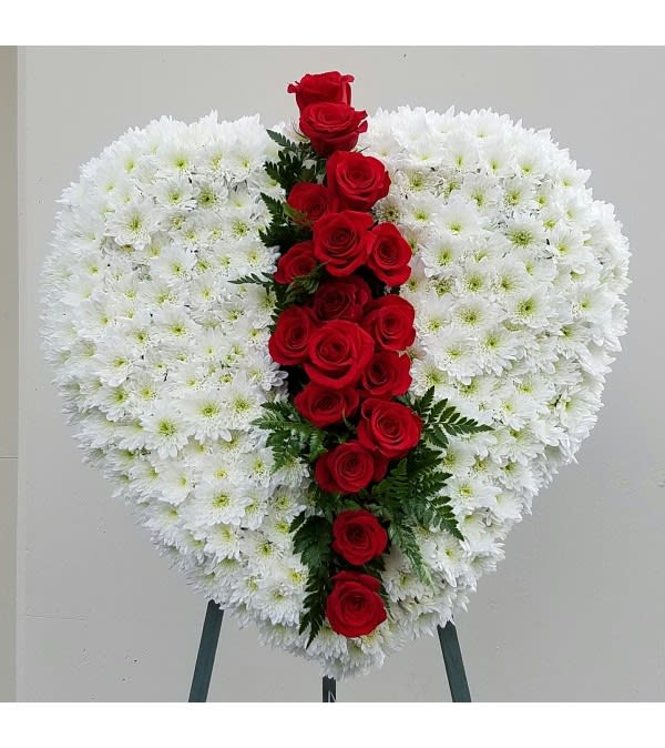 Heart-shaped white chrysanthemum wreath with a vertical line of red roses