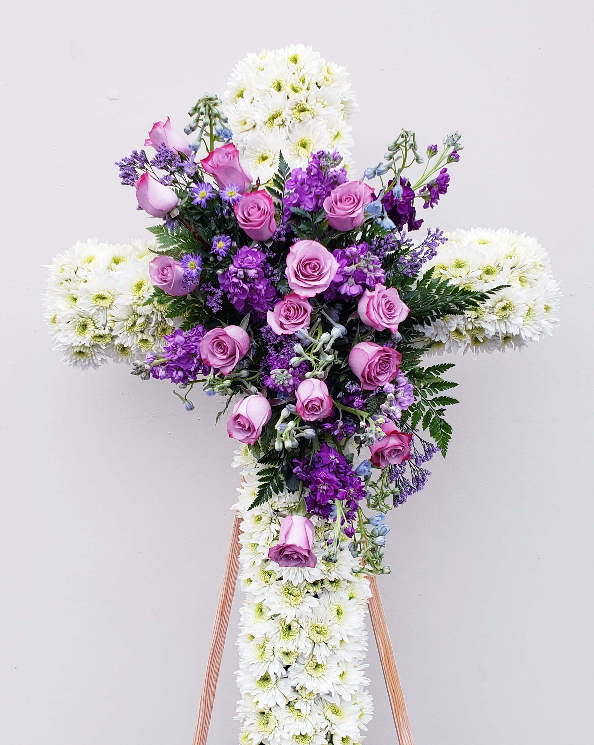 Cross-shaped floral spray with pink roses and white chrysanthemums