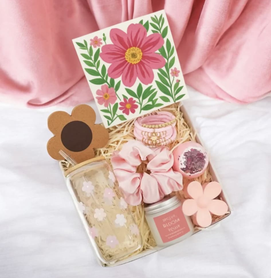 Pink gift box with floral card, scrunchie, jar, and tumbler