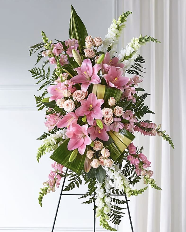 Standing floral spray with pink lilies, roses, and white snapdragons