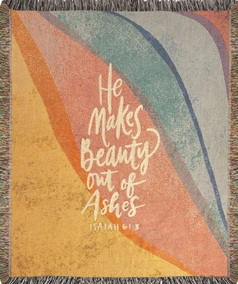 Rainbow wall hanging with the words "He makes beauty out of ashes"