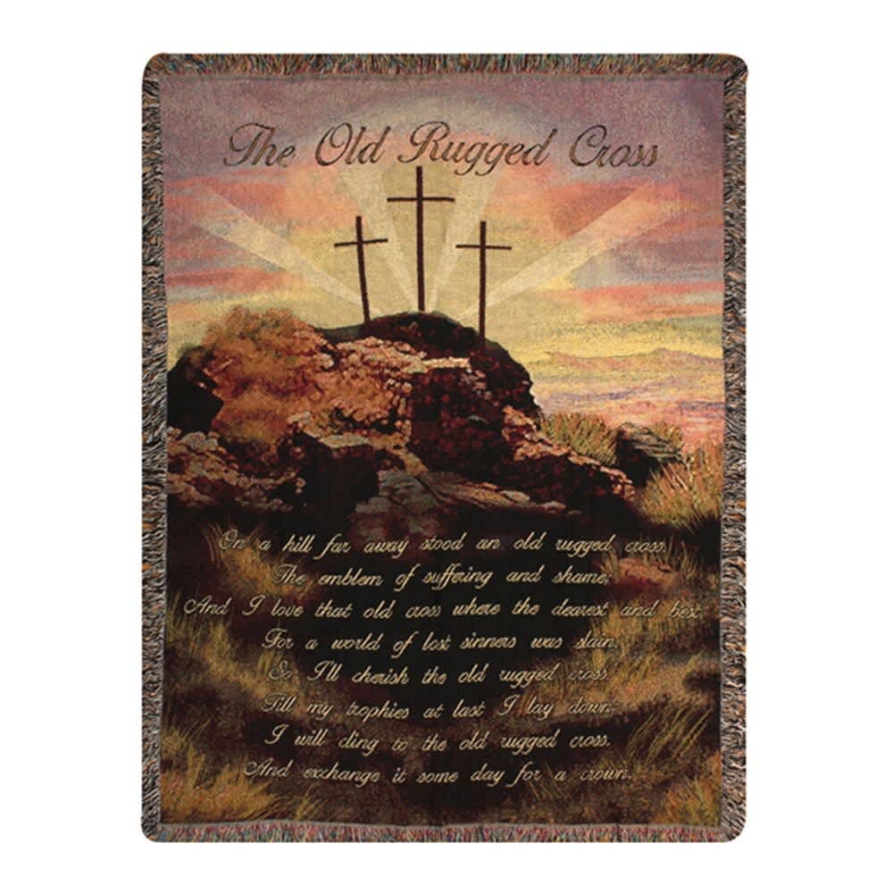 A woven blanket printed with a cross scene and the words "The Old Rugged Cross."