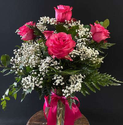 Pink roses with white baby's breath in a glass vase