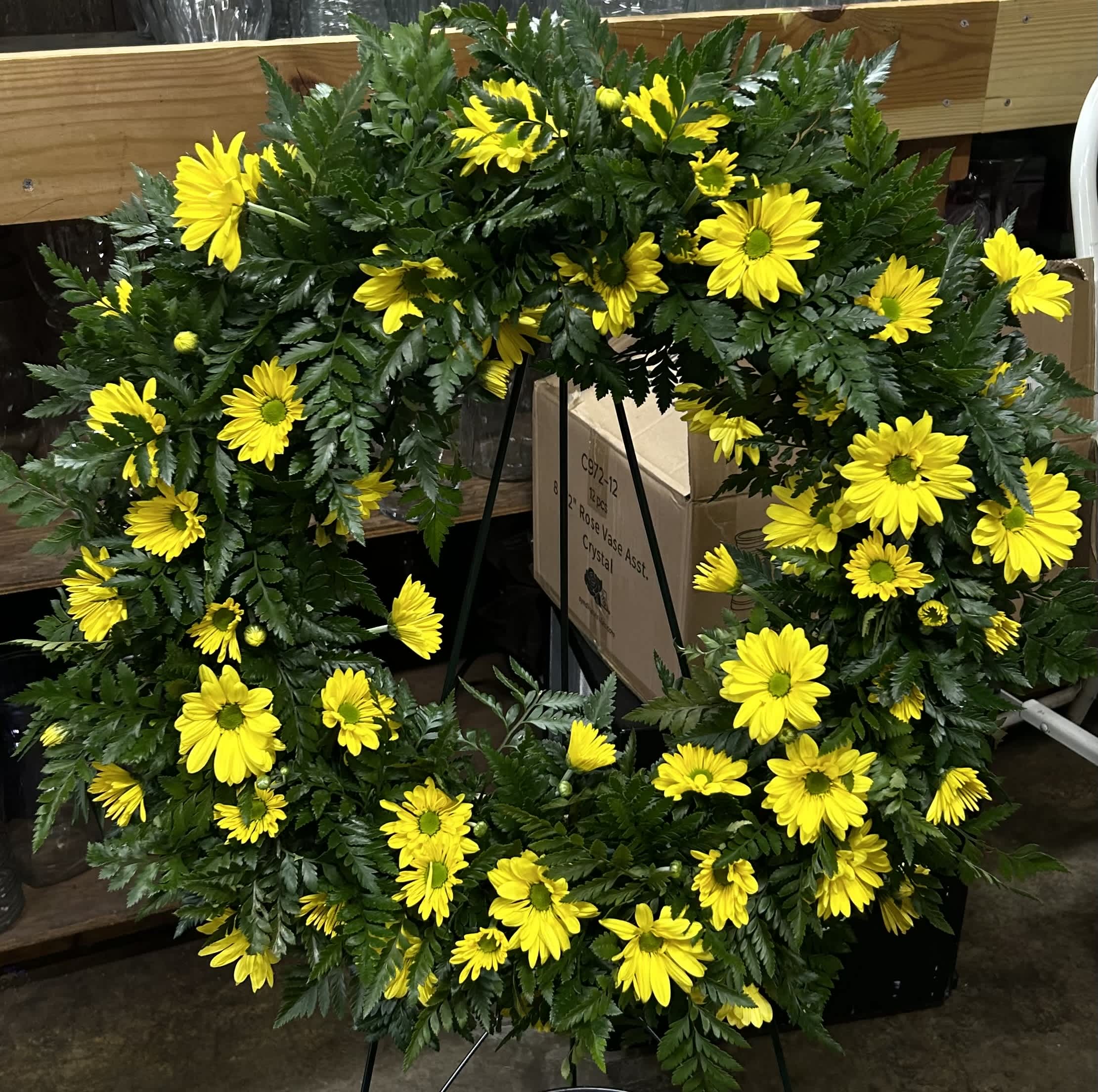 Yellow daisy wreath on a standing easel