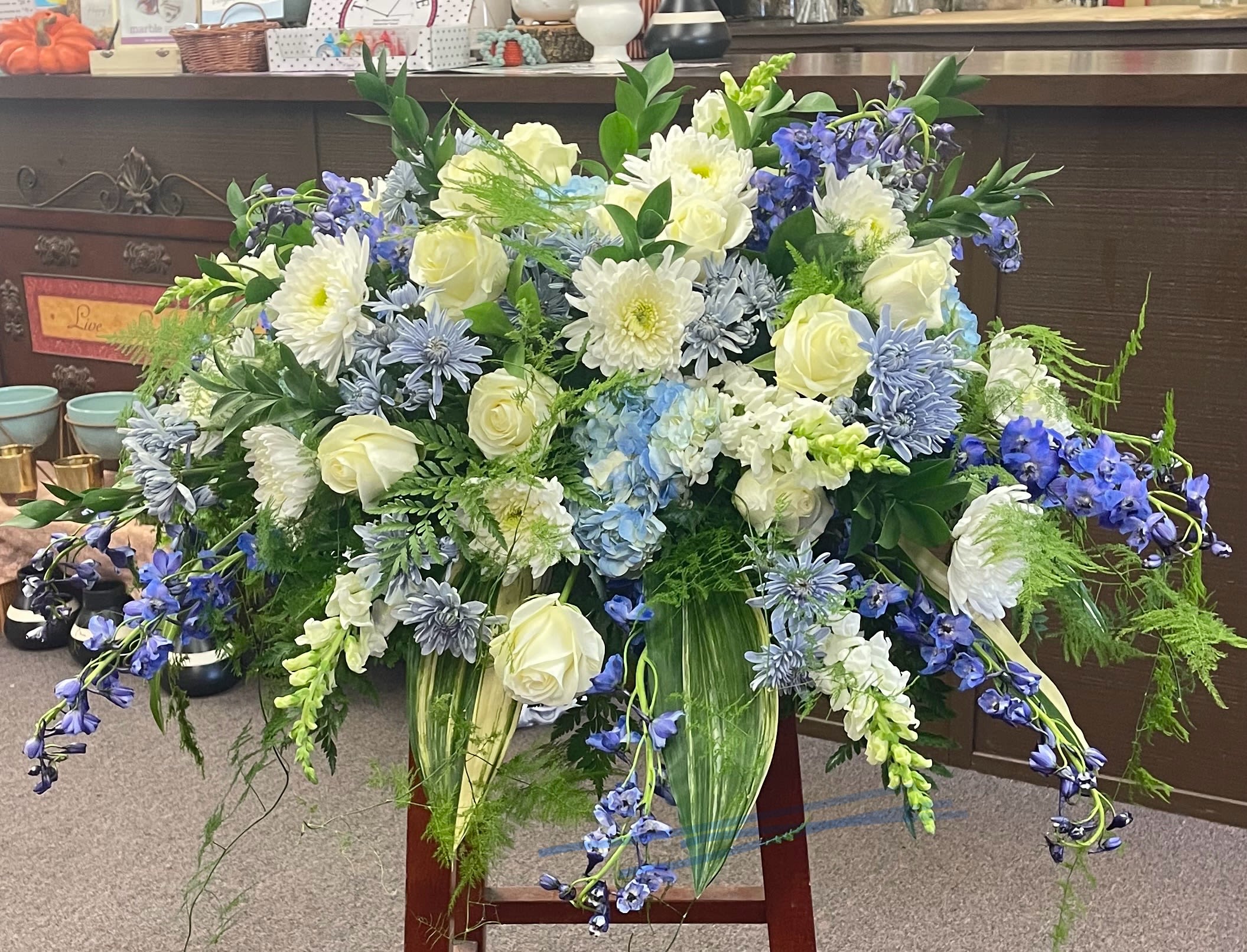 Large blue, white, and cream floral arrangement with cascading blooms