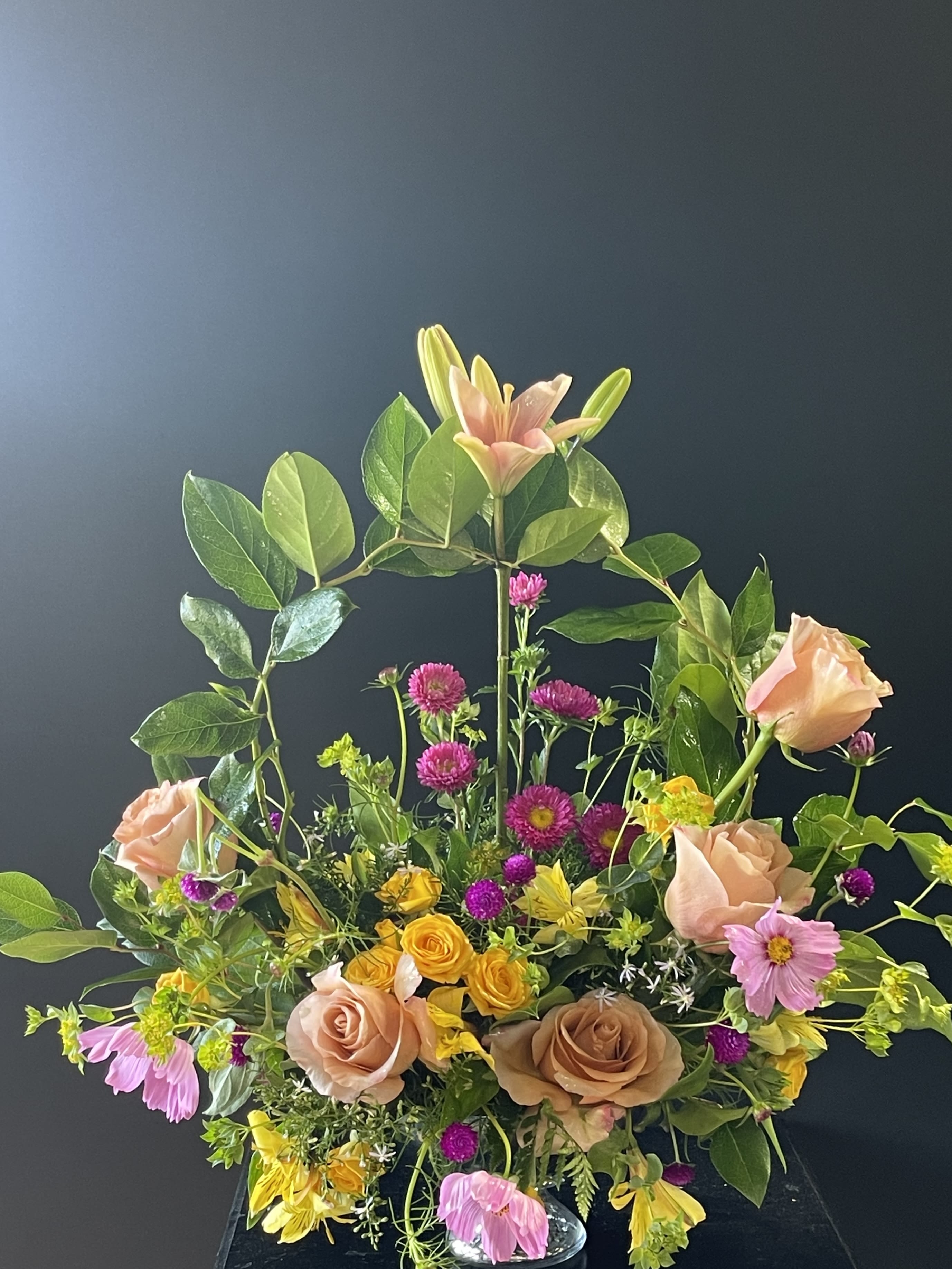Mixed bouquet with peach roses, lilies, and pink daisies