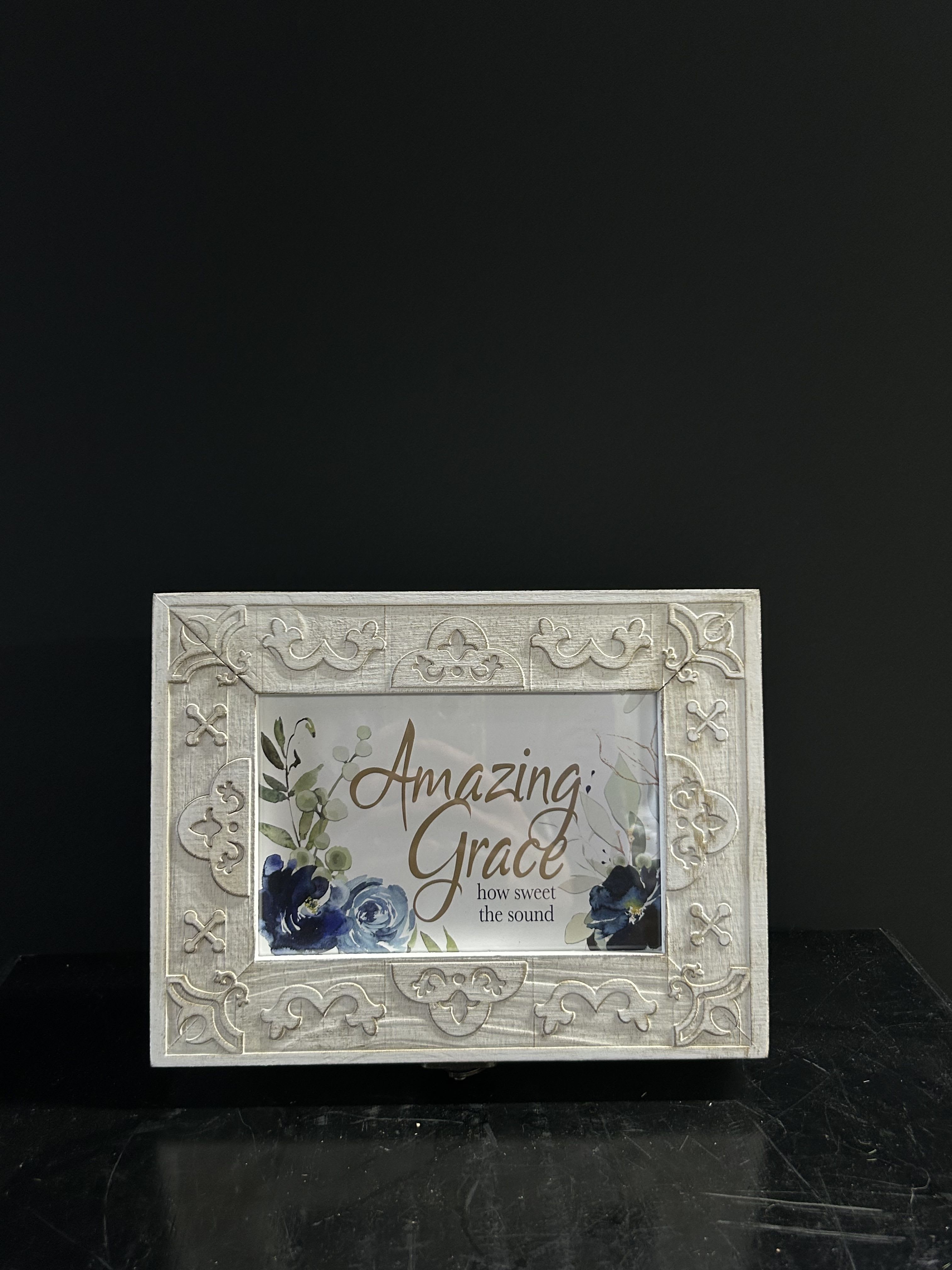 Decorative framed sign with floral artwork and the words Amazing Grace