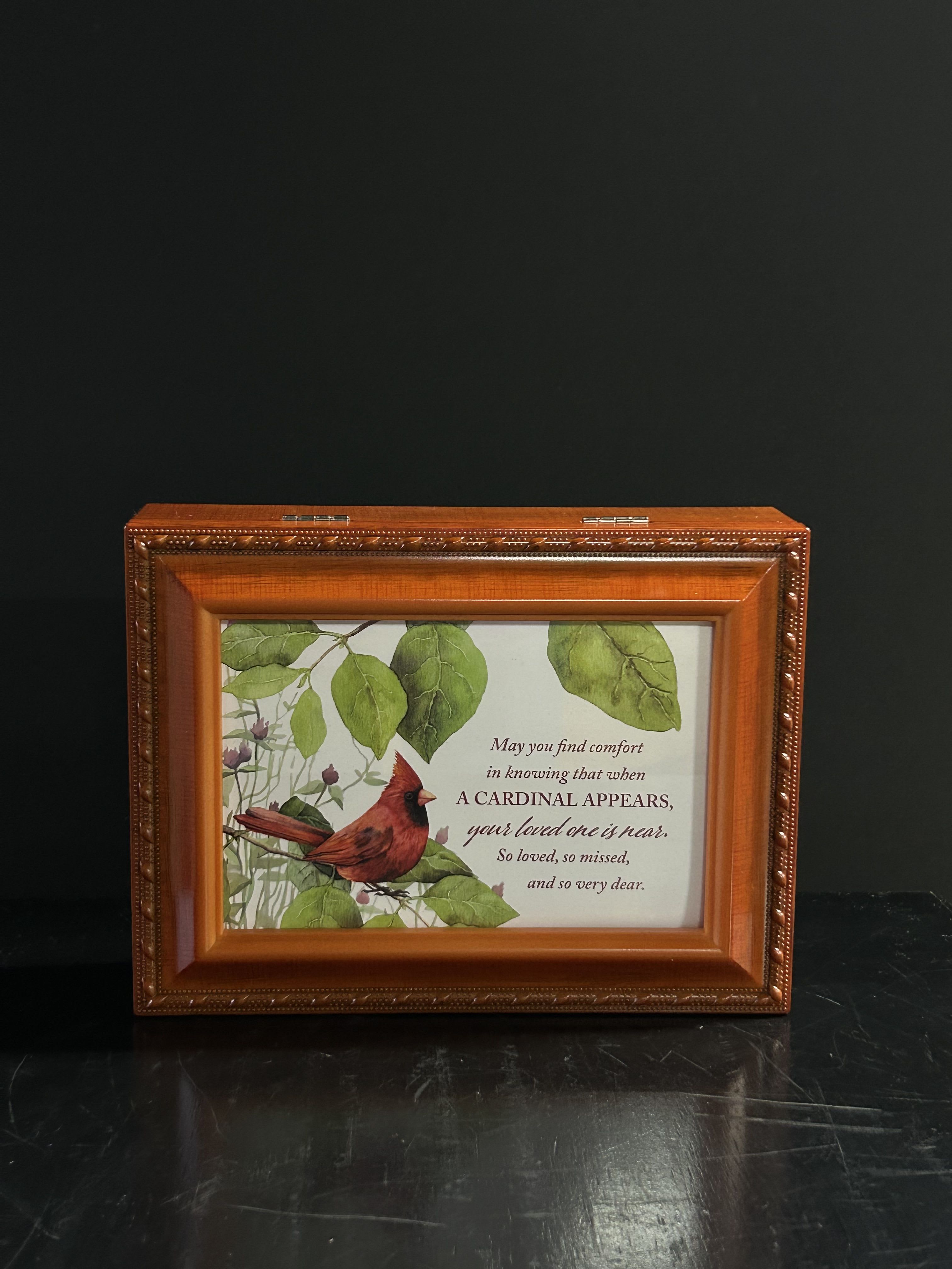 Framed memorial plaque with a cardinal and sympathy message