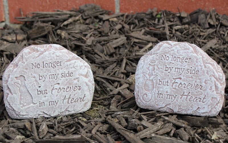 Two memorial stones engraved with angel designs and a remembrance message
