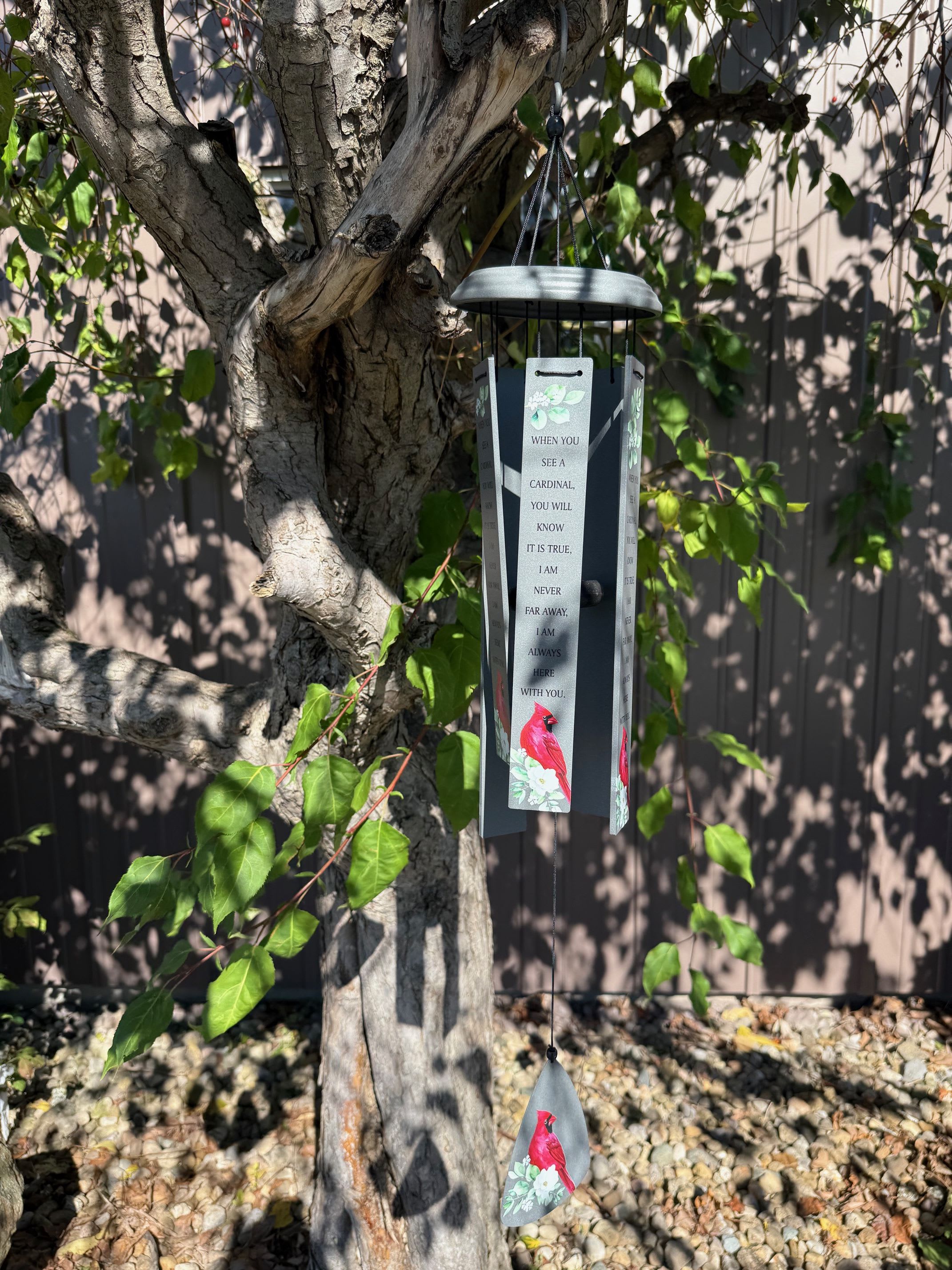Cardinal memorial wind chime hanging from a tree