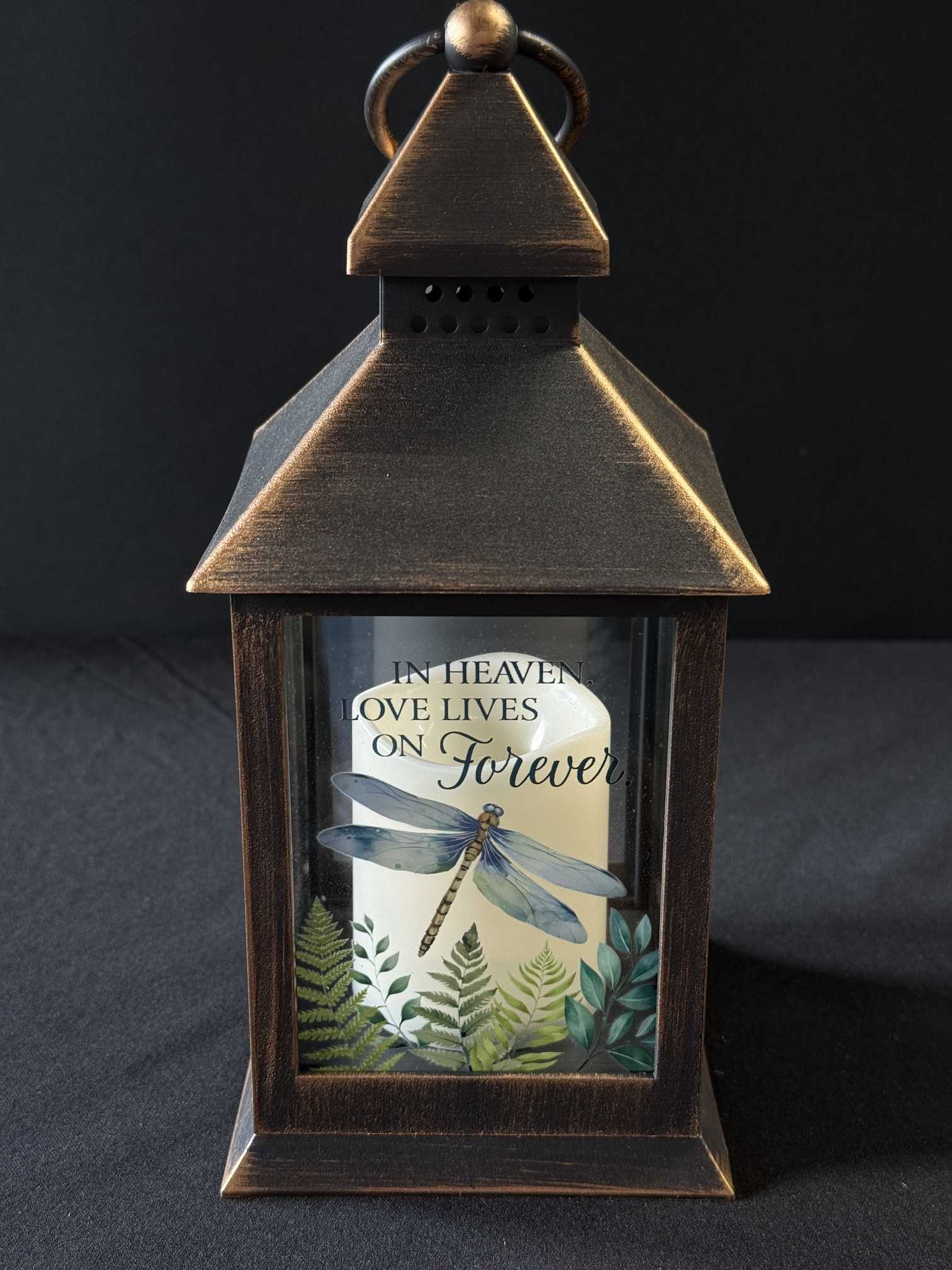 Decorative lantern with a candle and memorial text