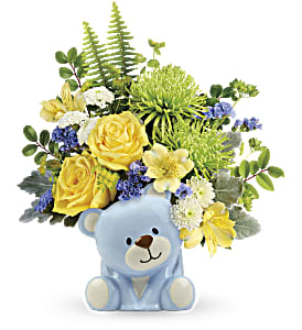 Yellow and white flower arrangement in a blue teddy bear container