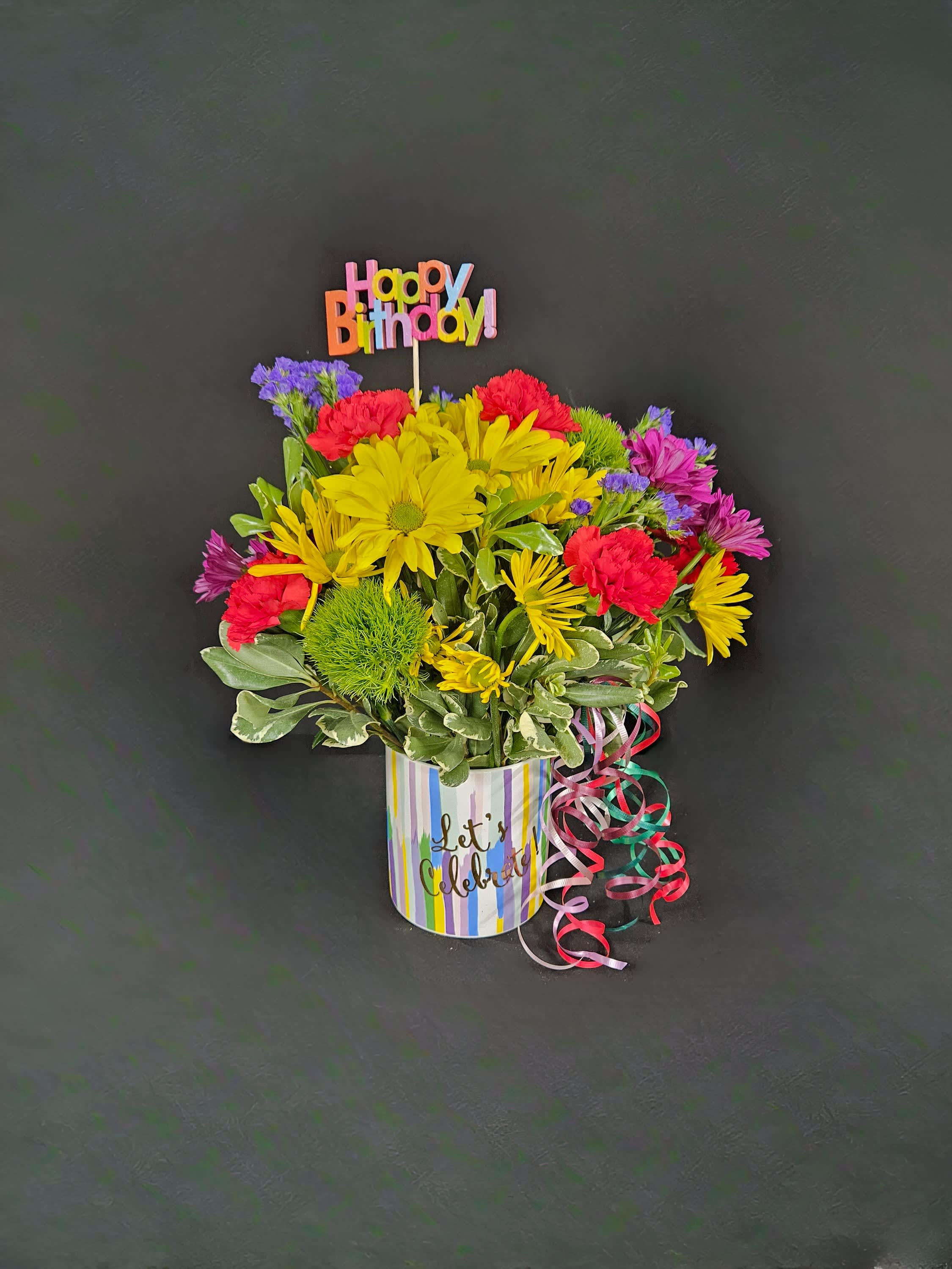 Colorful mixed bouquet in a striped pot with a Happy Birthday topper