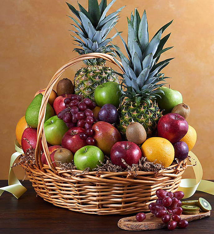 Fruit basket with pineapples, apples, grapes, oranges, and kiwis