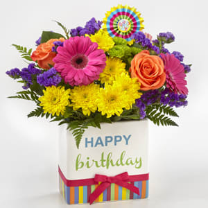 Colorful bouquet in a birthday gift box with a ribbon