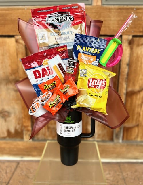 Snack bouquet in a black tumbler with chips, candy, jerky, and peanuts