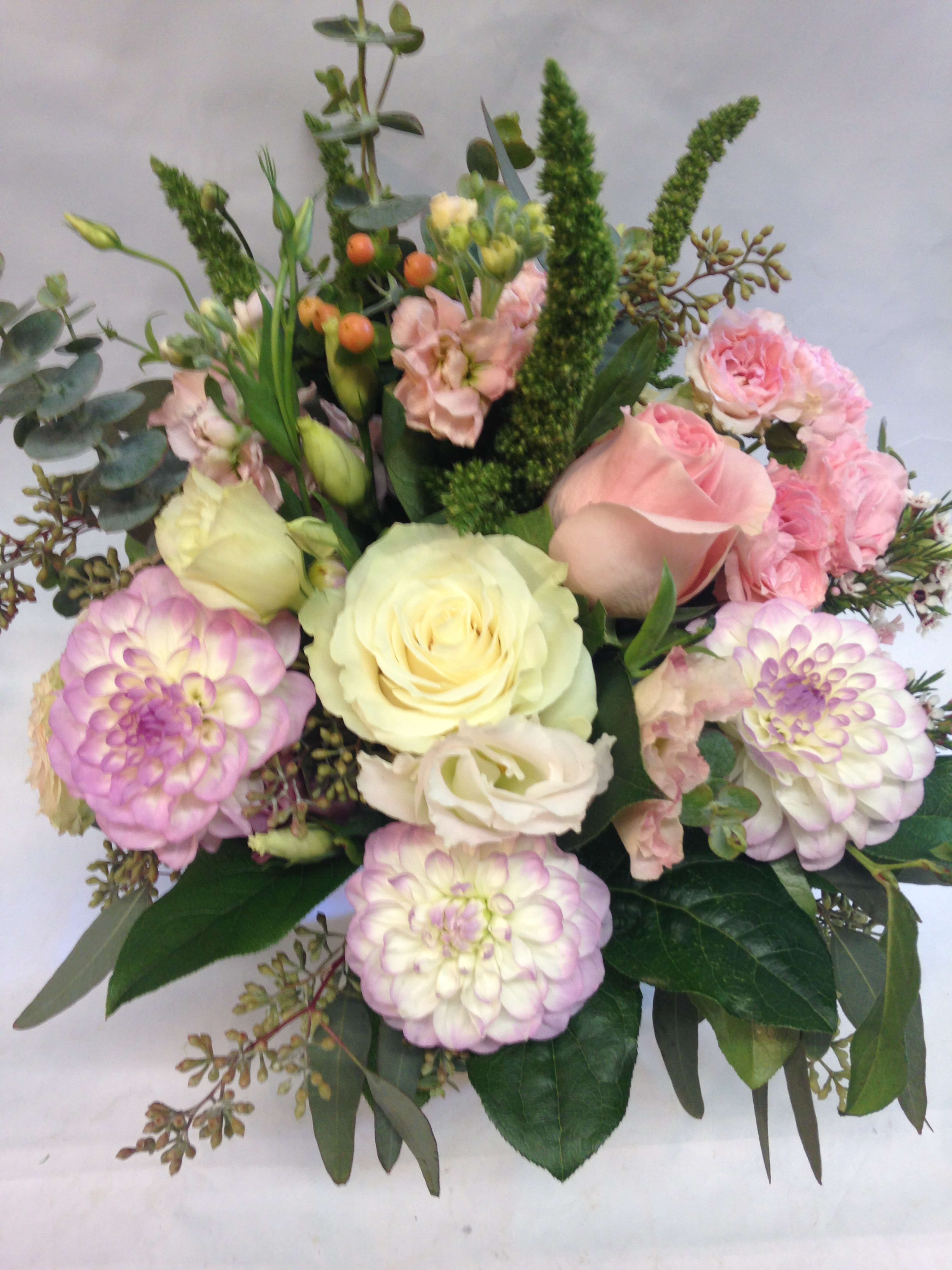 Bouquet of pink and cream roses with lavender dahlias and greenery
