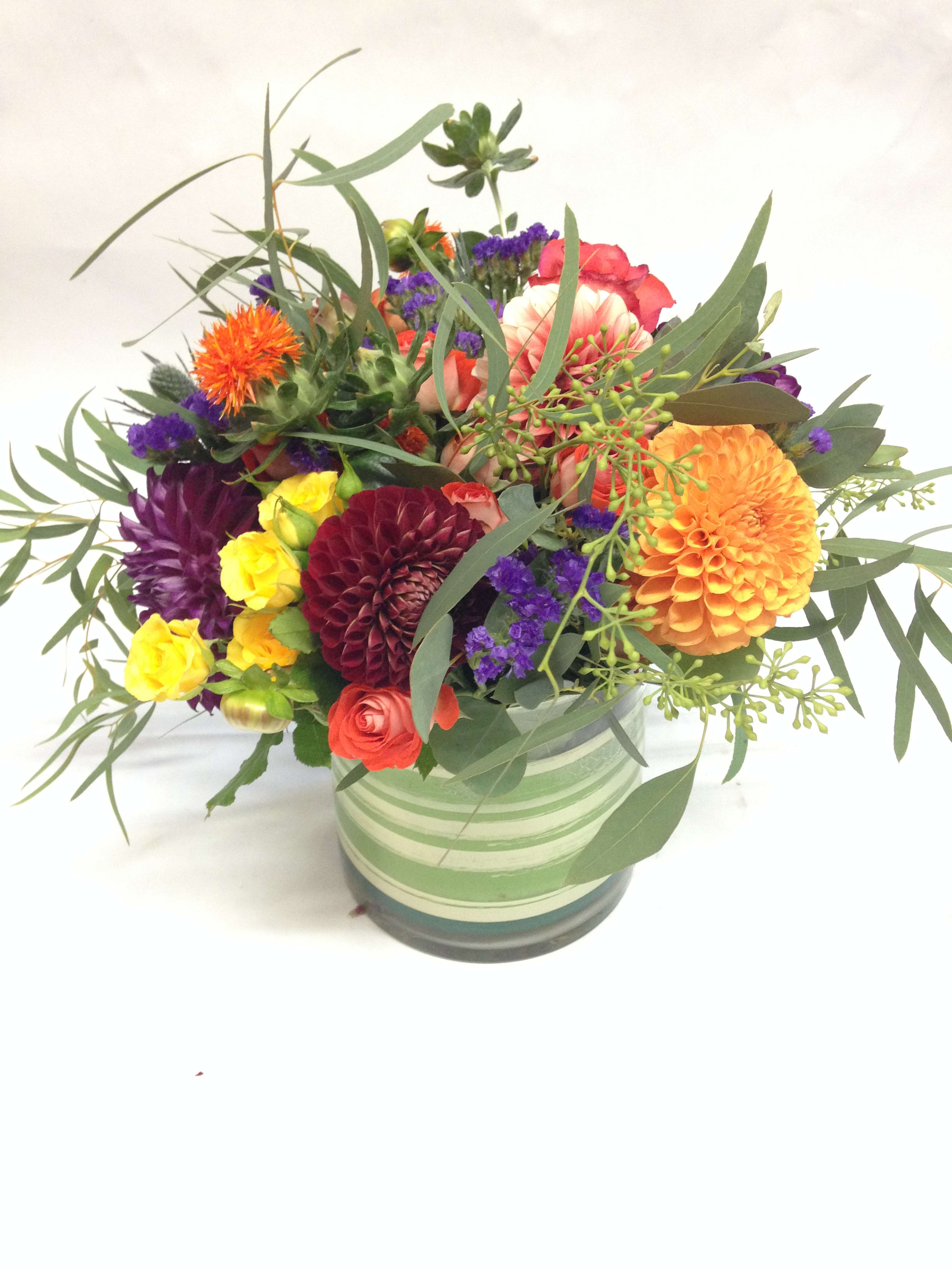 Everything Dahlia - This bright and colorful arrangement comes complete with a variety of dahlias, statice, spray roses, aziatic lilies, safflower and seeded eucalyptus.  (Some flowers may be subject to change depending on the season. We will contact you with available flower substitutions; please contact us with specific questions if you are concerned with flower availability, thanks!)  Featured arrangement: $155 (Regular Price)