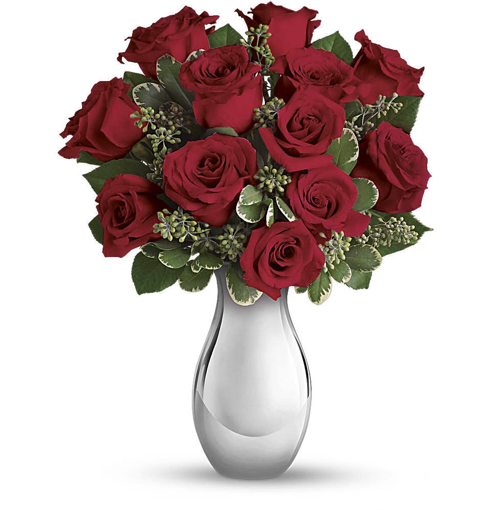 Arrangement of red roses in a shiny silver vase
