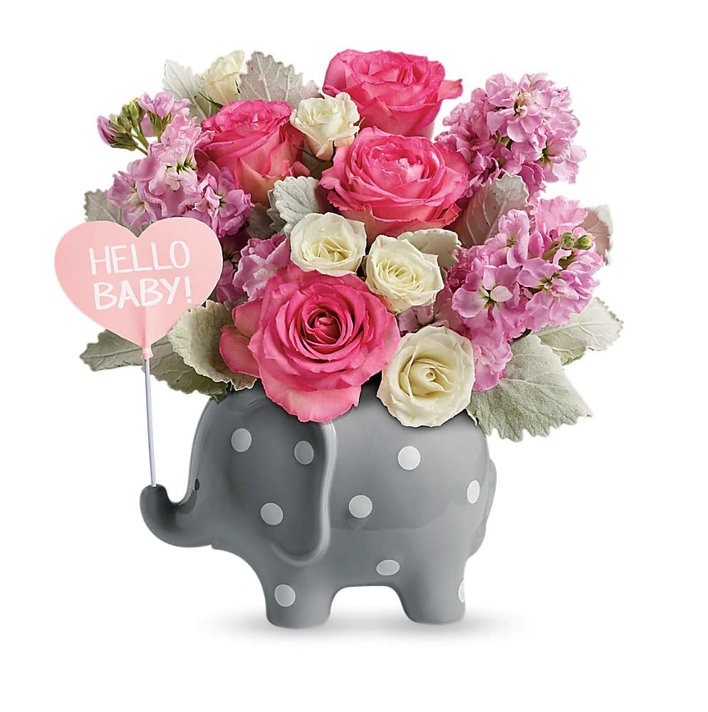Pink and white roses and stock in a gray polka-dot elephant vase with a heart pick that reads HELLO BABY.