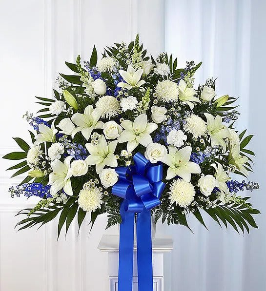 Heartfelt Sympathies Blue &amp; White Funeral Standing Basket - Maybe they loved the color blue…or maybe they enjoyed the calmness of the ocean under a cloudless sky. Our majestic blue and white standing basket arrangement will help honor their memory in a unique and meaningful way. Artistically designed by our expert florists with rich blue and pristine white blooms, this floral tribute is a heartfelt expression of your deepest sympathies.