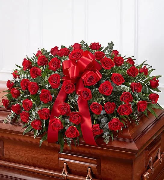 Red Rose Casket Cover - When someone near and dear to us passes, it’s natural to want to express all the love and admiration we have in our hearts. Nothing conveys this better than a classic display of red roses. Our half casket cover, crafted with care and artistry by our expert florists with over 50 premium red roses, fresh greenery, and accented with a red satin ribbon, is an unforgettable way to commemorate a lifetime of esteem and adoration.  Add a Sympathy Banner to this arrangement! https://katyflowershop.com/katy-katy-flower-shop/sympathy-banner.html