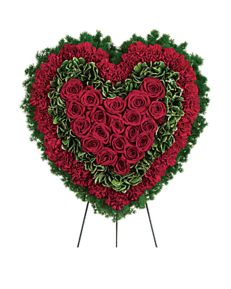 Majestic Heart - Speak from your heart. This majestic funeral display is a charming, heartfelt way to express your love, composed of sympathy red roses and carnations with variegated pittosporum.  Red carnations, red roses, variegated pittosporum are arranged into a touching heart design that's presented on a wire easel.  Size is of the heart without easel is  21"H 21"W