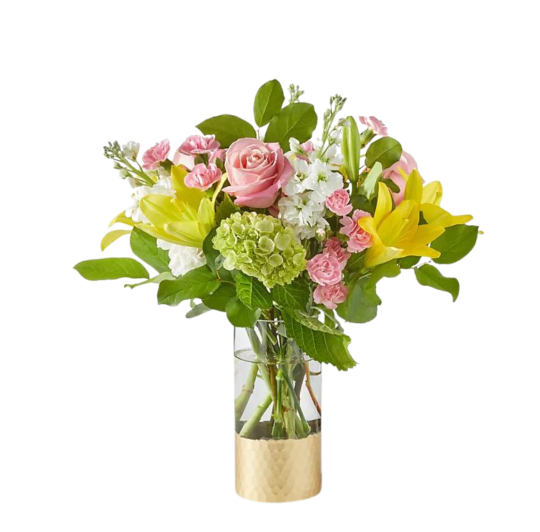 Bouquet of pink roses, yellow lilies, and white flowers in a glass vase