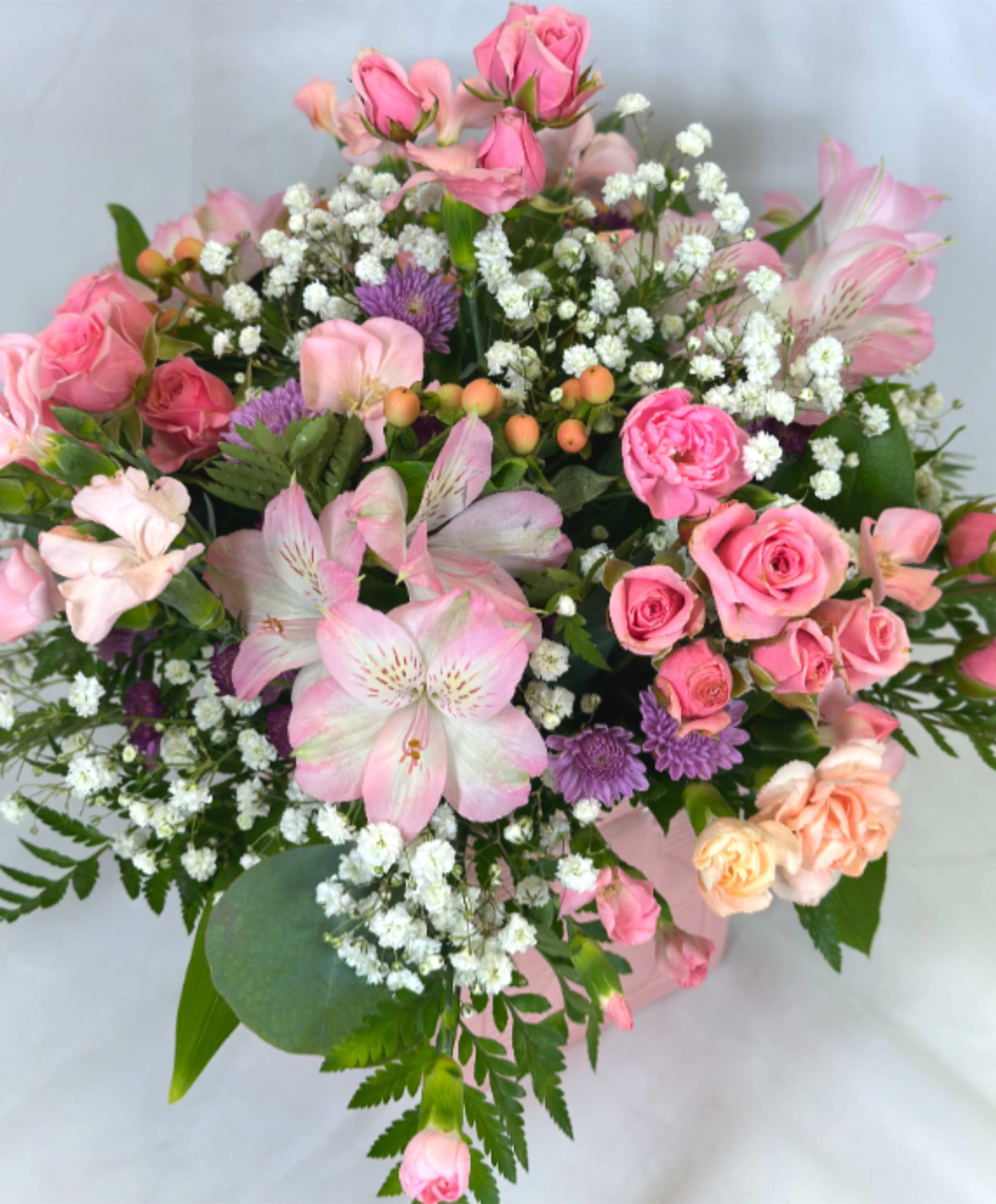 Baby Pink - This is a delightful arrangement for a new mom or dad! It features pretty pink blooms in a pink ceramic baby block cube.