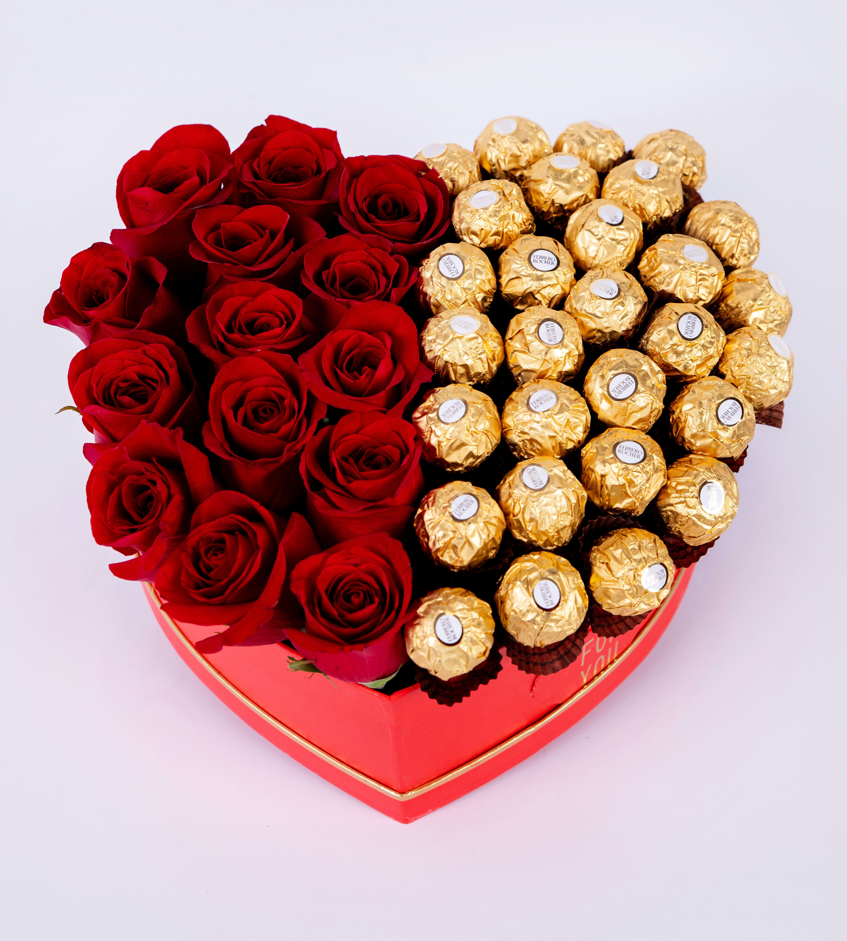 Heart-shaped box with red roses and gold-wrapped chocolates