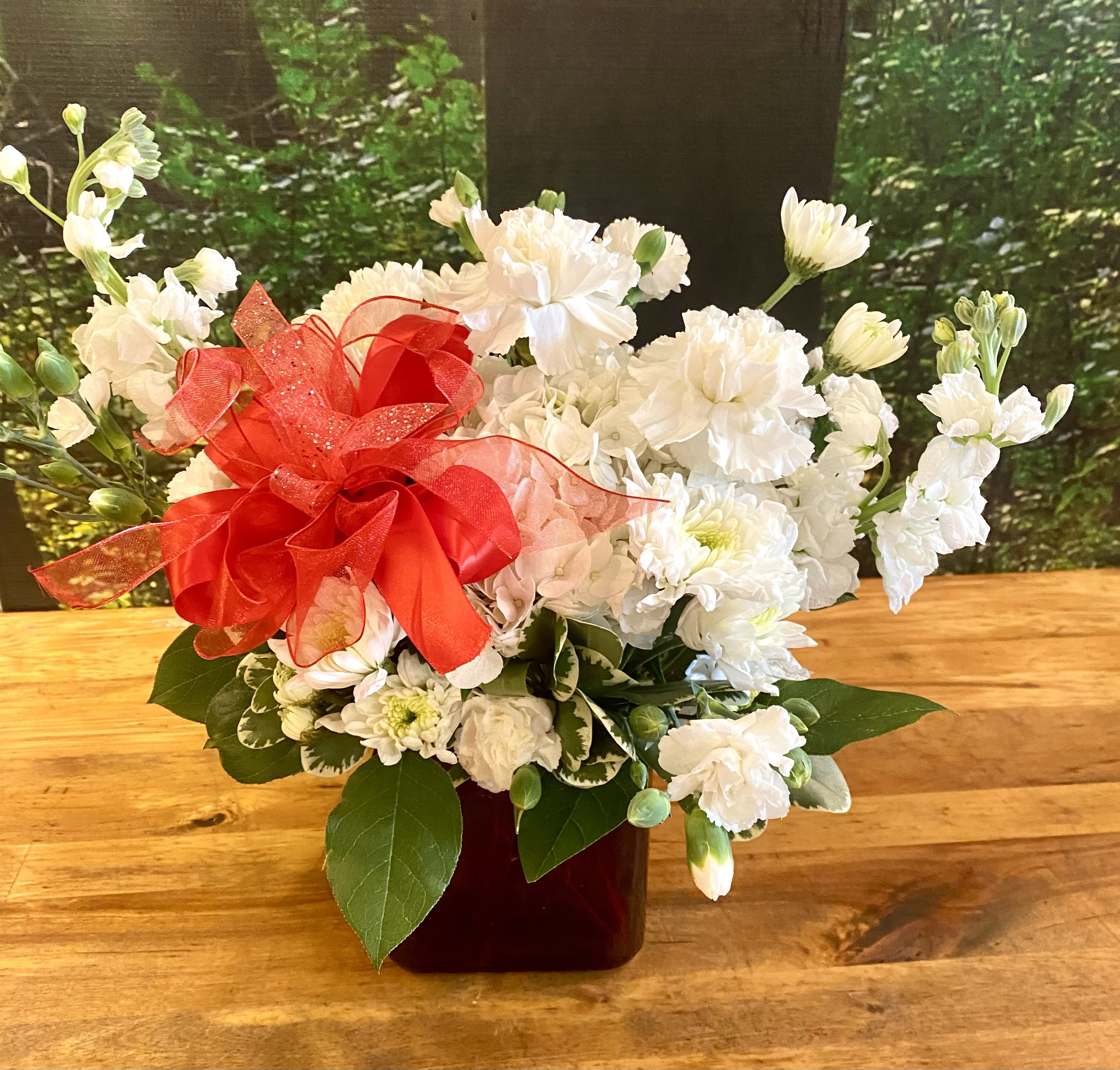 Classic Chi Omega - Custom designed specifically for the Chi Omega Sorority, this beautiful and petite floral creation features the house flower, white Carnations. A beautiful arrangement creating a classic look to celebrate your special Chi-Omega!  