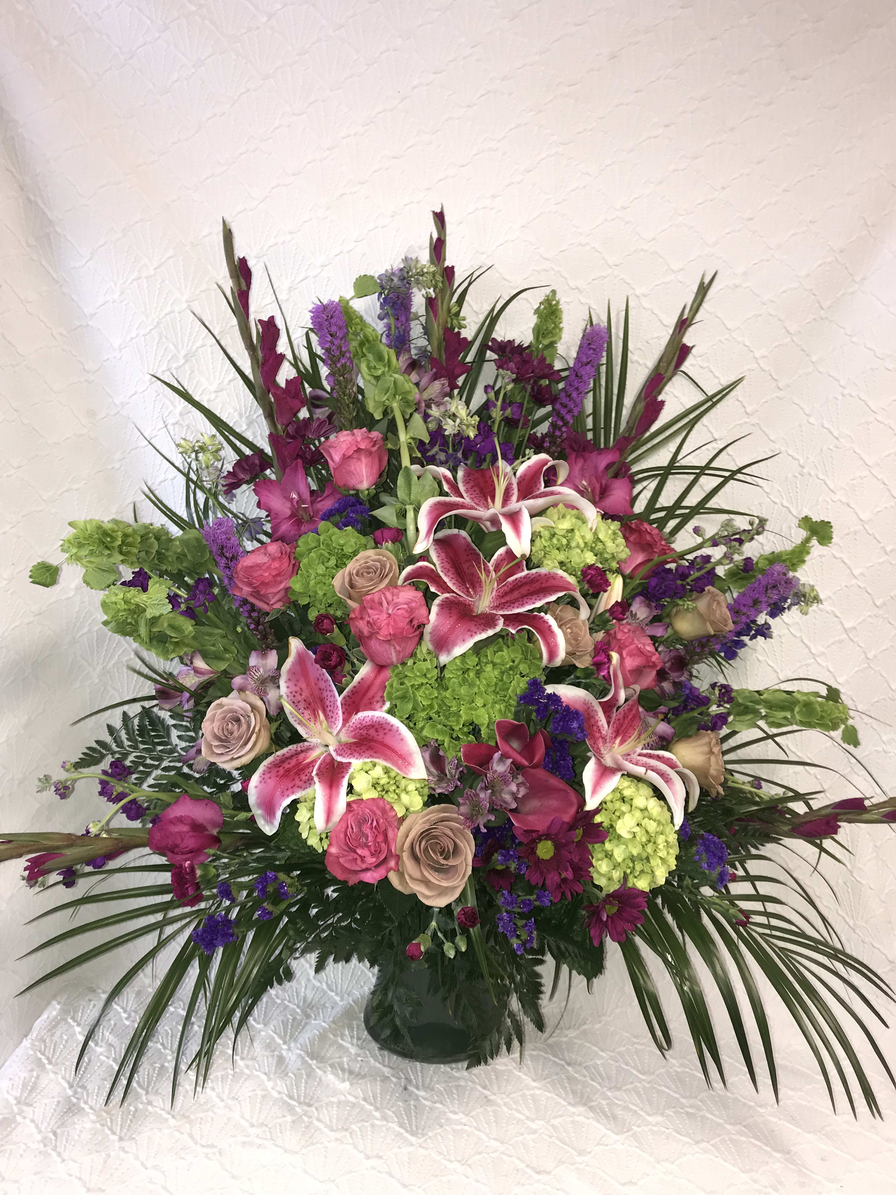 Large mixed bouquet with pink lilies and roses in a vase