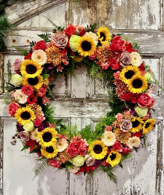 Heart-shaped floral wreath with sunflowers and roses