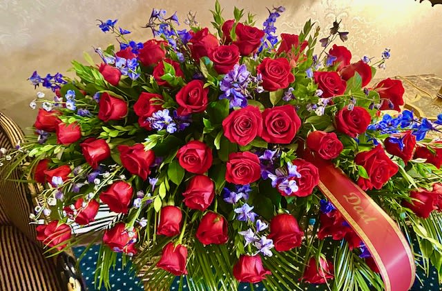 Large bouquet of red roses with blue and purple flowers