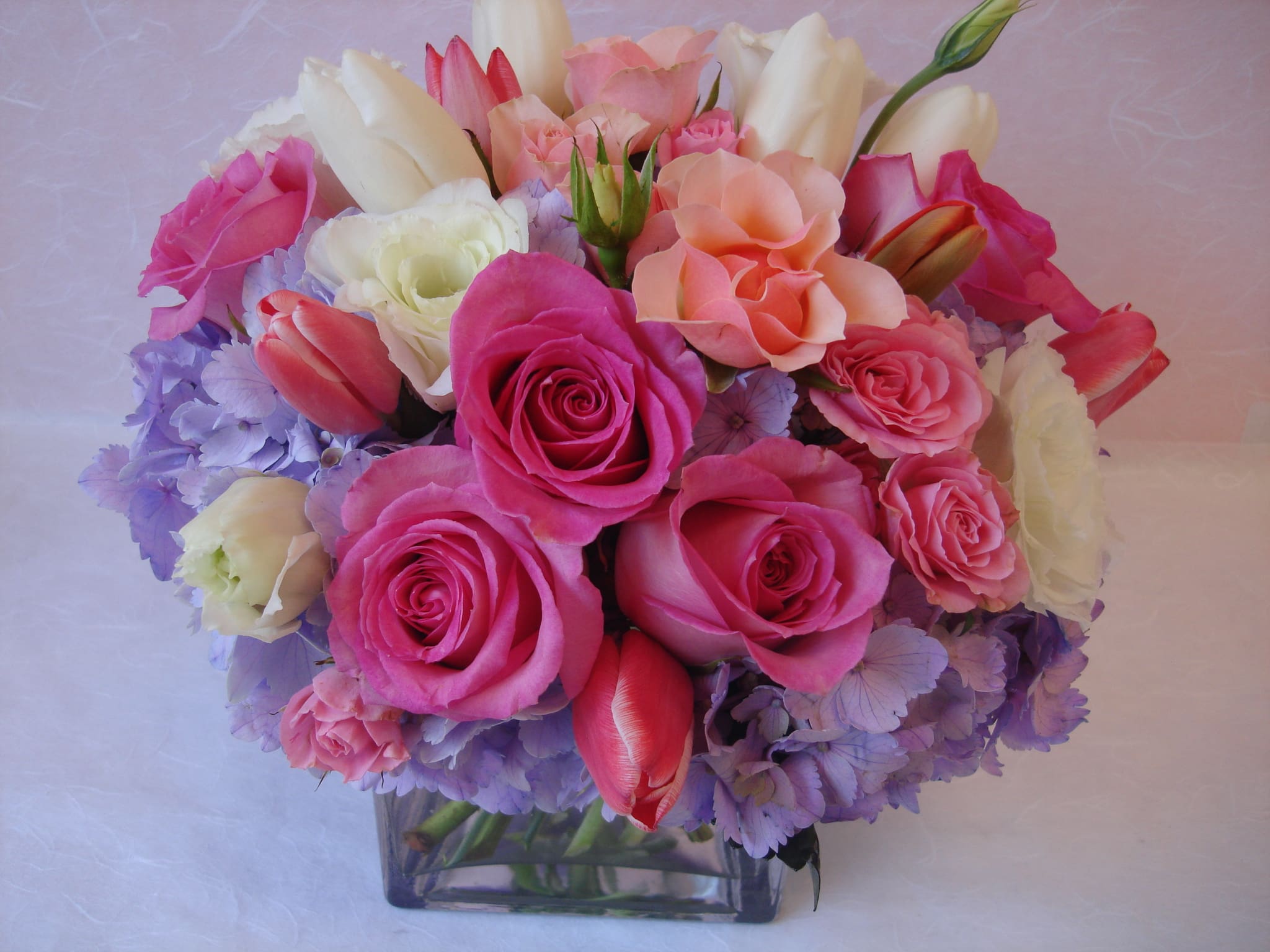 Lady Love by Fillmore Florist San Francisco - Both chic and modern in style, "Lady Love" is the perfect botanical gift to brighten up your sweetheart's day. Hand-crafted by the experienced designers at Fillmore Florist, this lovely arrangement features a stunning blend of lavender hydrangeas, white lisianthus, pink roses, spray roses, and a mix of white and pink tulips, all beautifully displayed in a clear glass cube container. When looking for premier flower delivery in San Francisco, this stylish creation offers an unforgettable way to express your affection. Expertly styled by our professional Florist San Francisco team, every stem is arranged to ensure a fresh, elegant presentation. Whether you need reliable flower delivery San Francisco clients trust or an experienced Florist San in Francisco to manage your floral gifts, we provide seamless San Francisco flower delivery. Count on your dedicated San Francisco florist to bring modern sophistication and beauty to every special occasion.  Approximate Dimensions: 10" H x 8" W