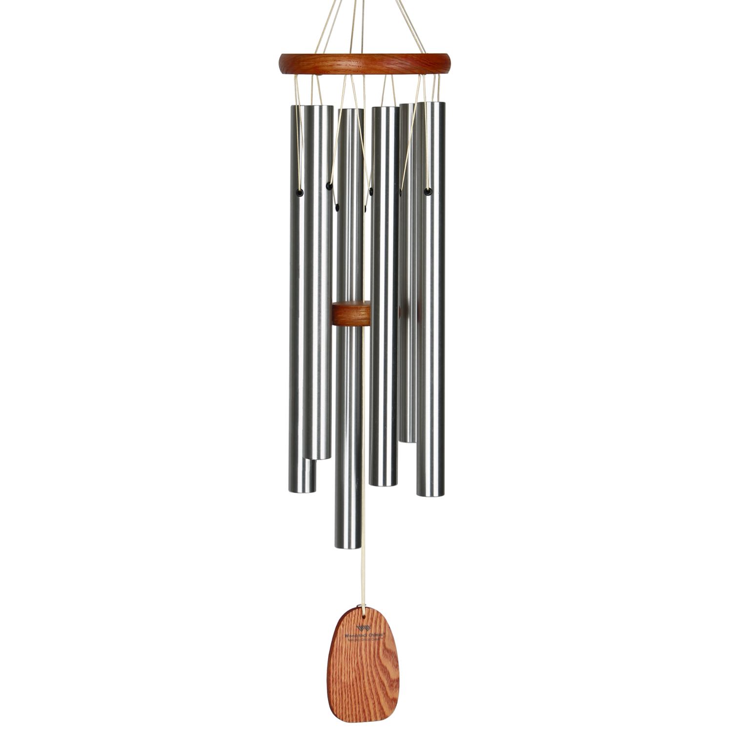 Metal wind chime with wooden accents hanging on a white background