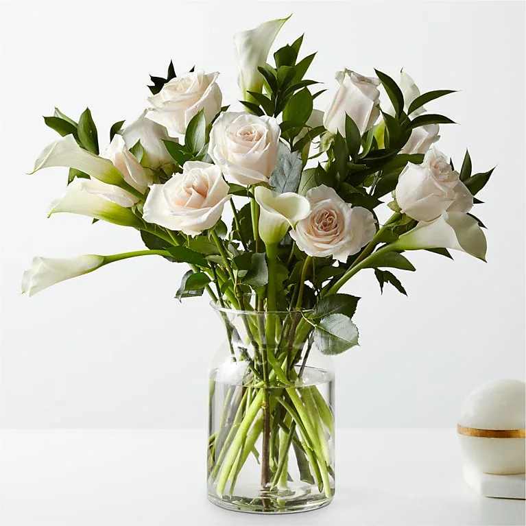 Vision in Ivory Rose and Calla Lily Bouquet - A stunning selection of roses and calla lilies come together to create this illuminating bouquet. Picked fresh from the farm, let this grand arrangement take center stage in your home and add a touch of elegance wherever it's placed.