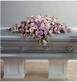 Pink floral casket spray with lilies and roses