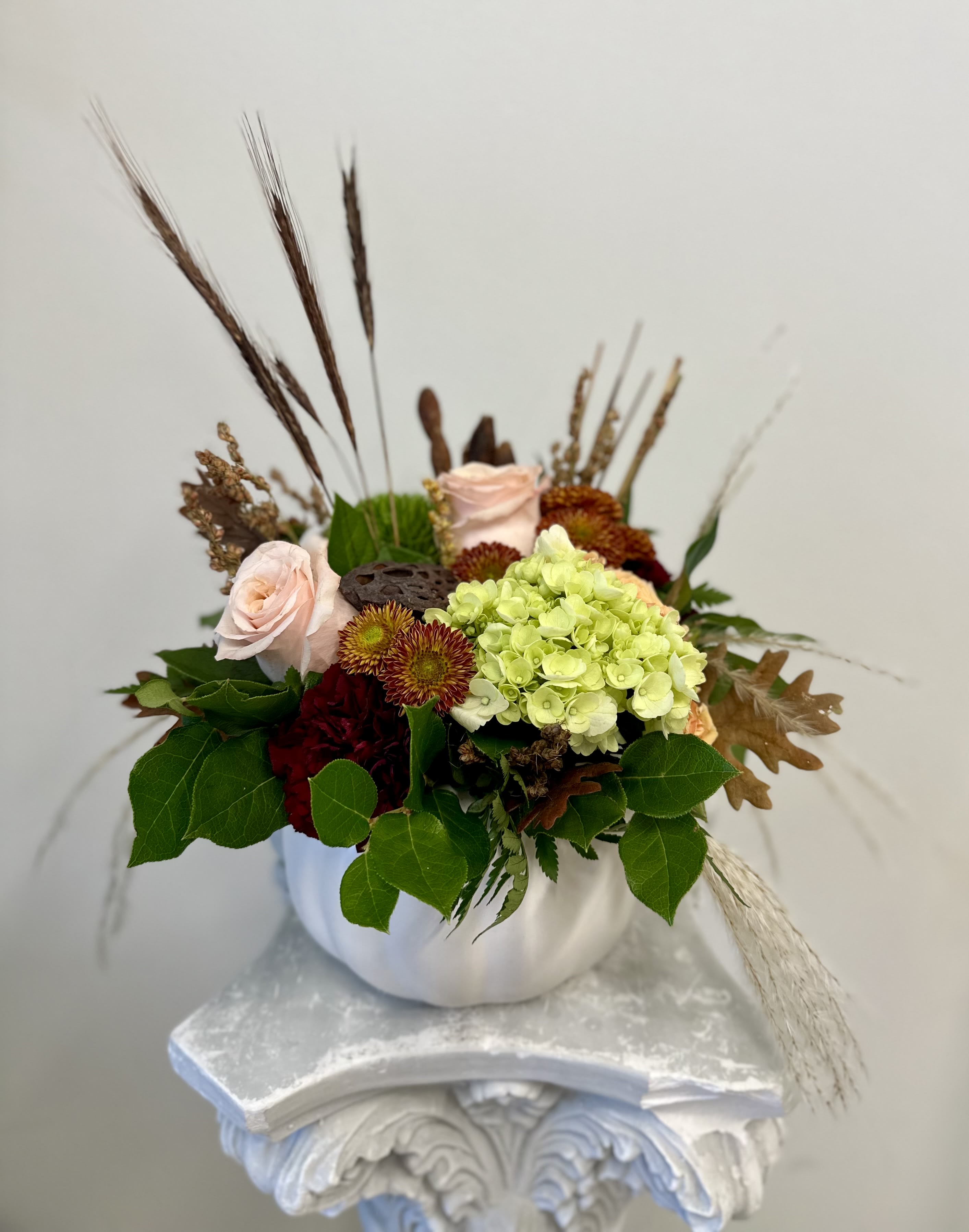 Fall Elegance b Westford Florist Art by Veny - Enhance your holiday gatherings with the exquisite Fall Elegance by Westford Florist Art, crafted by Veny. This stunning arrangement showcases a vibrant selection of autumnal blooms, artfully designed to capture the essence of the season. The rich textures and warm hues invite an atmosphere of sophistication and comfort, making it the perfect centerpiece for Thanksgiving celebrations. Whether adorning your dining table or gracing a sideboard, this floral masterpiece adds an elegant touch to any setting. Elevate your festive decor and create lasting memories with a piece that embodies both beauty and warmth. Celebrate the spirit of fall in style with Fall Elegance—where nature's artistry meets refined design.