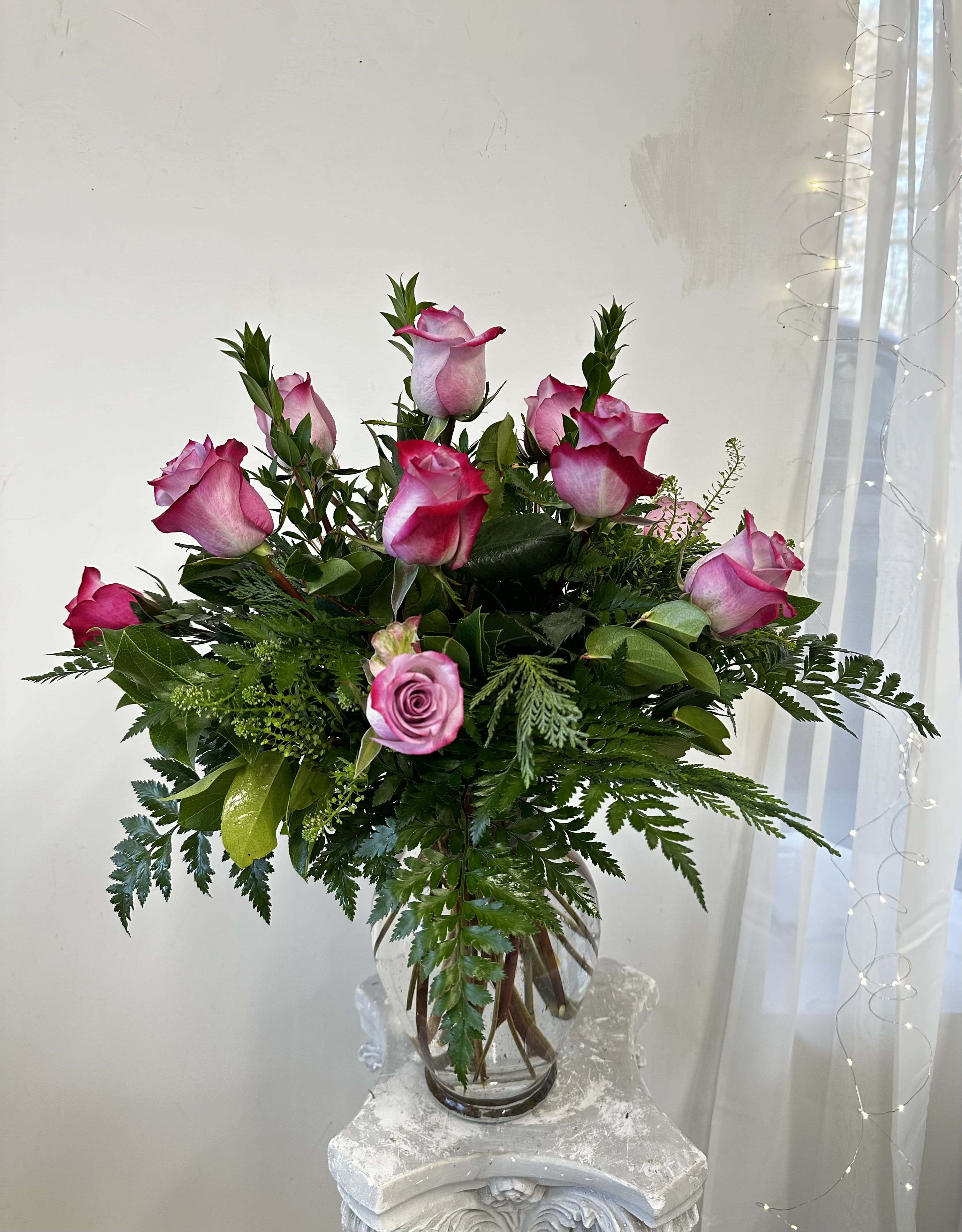 One Dozen Lavender Roses by Westford Florist  Floral Art by Veny - When it comes to expressing your love and appreciation for someone special, flowers are always a classic choice. And when it comes to finding the perfect flower arrangement that exudes elegance and beauty, look no further than Westford Florist's Art by Veny One Dozen Lavender Roses. Imagine walking into a room and being greeted by the sight of a tall glass vase filled with twelve delicate lavender roses. The soft hue of these roses instantly brings a sense of serenity and tranquility, making them an ideal gift for any occasion. Each rose is carefully hand-selected by our expert florists and arranged in such a way that showcases their natural beauty. And as with all our arrangements at Westford Florist Floral Art by Veny, we use only the freshest-cut blooms sourced from trusted local growers to ensure longevity and quality. It has never been easier to surprise someone special with these beautiful blooms thanks to our easy online ordering system. Then sit back and relax while we take care of delivering your heartfelt sentiment right to their doorstep. Ordering from Westford Florist means not only getting high-quality products but also supporting a local business dedicated to providing exceptional service and creating unforgettable experiences. So, spread some love and brighten someone's day with our One Dozen Lavender Roses today!