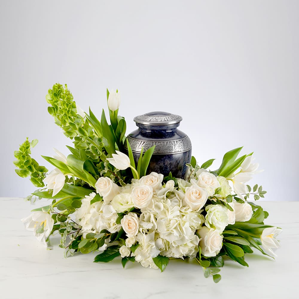 White floral arrangement with a dark urn centerpiece